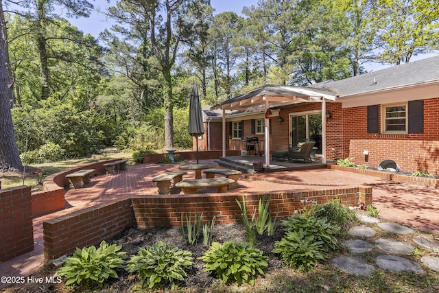 back of property featuring brick siding and a patio