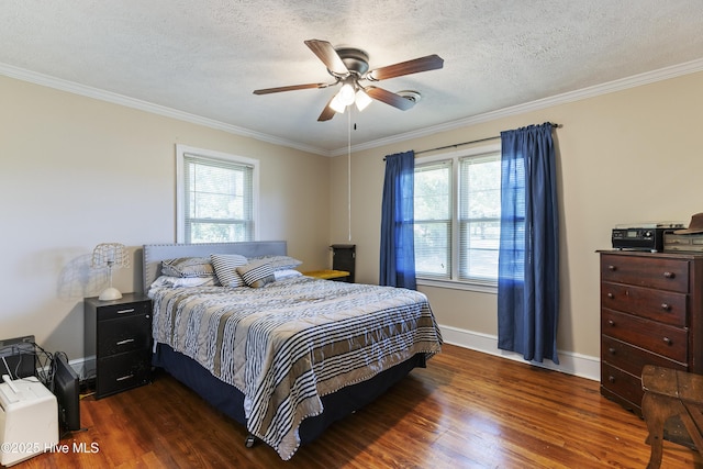 bedroom with wood finished floors, ornamental molding, and multiple windows