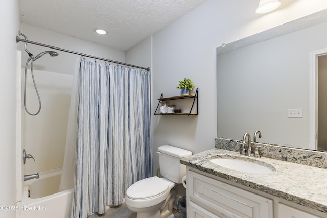 full bathroom featuring shower / bath combo, vanity, a textured ceiling, and toilet