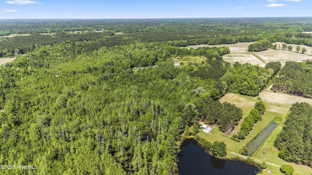 aerial view with a forest view and a water view