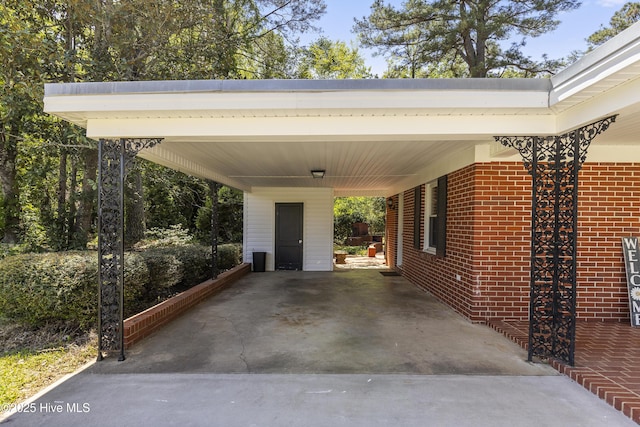 view of car parking with driveway and an attached carport
