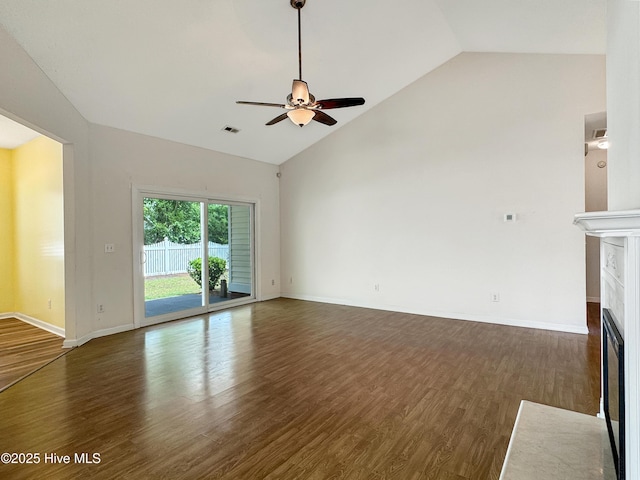 unfurnished living room featuring a tile fireplace, a ceiling fan, wood finished floors, baseboards, and high vaulted ceiling