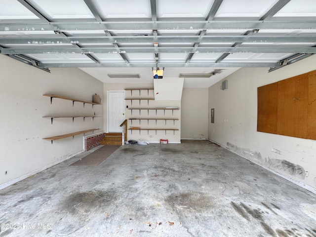 garage featuring a garage door opener and electric panel