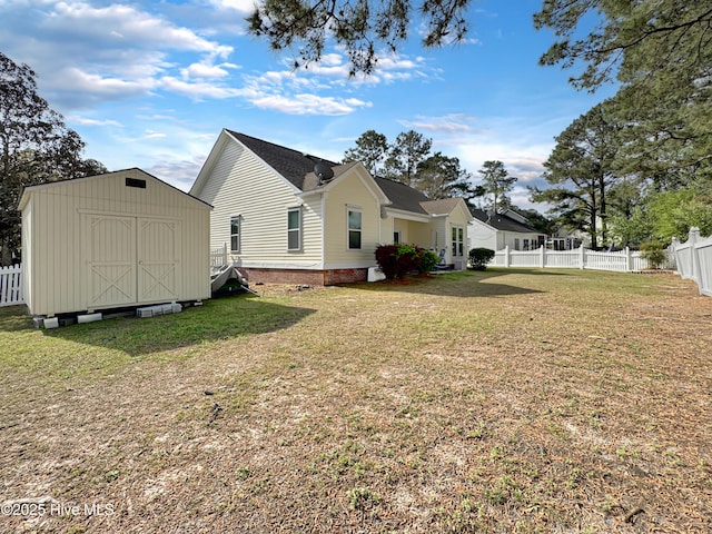 back of property featuring a storage unit and an outbuilding