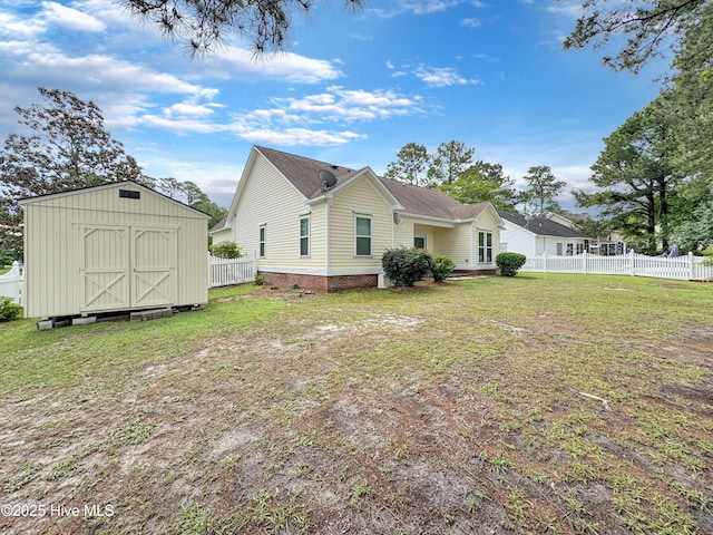 back of house featuring a storage shed and an outdoor structure