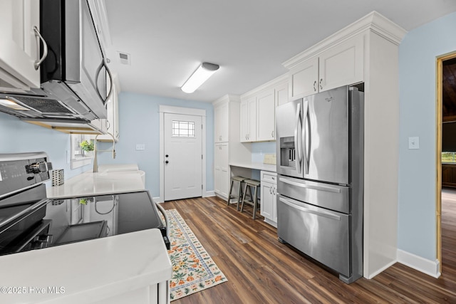 1450 State Camp Rd, Vanceboro, NC 28586 - kitchen with stainless steel appliances, white cabinetry, dark wood-style floors, and baseboards