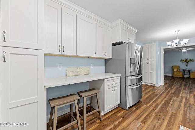 1450 State Camp Rd, Vanceboro, NC 28586 - kitchen featuring stainless steel refrigerator with ice dispenser, a chandelier, white cabinetry, dark wood finished floors, and a breakfast bar area
