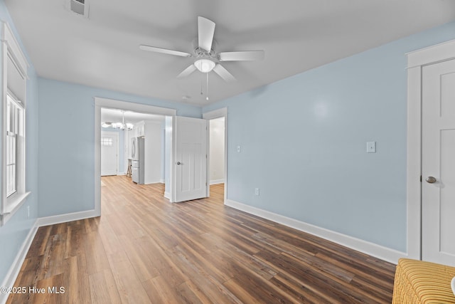 1450 State Camp Rd, Vanceboro, NC 28586 - unfurnished living room with a chandelier, baseboards, a ceiling fan, and wood finished floors
