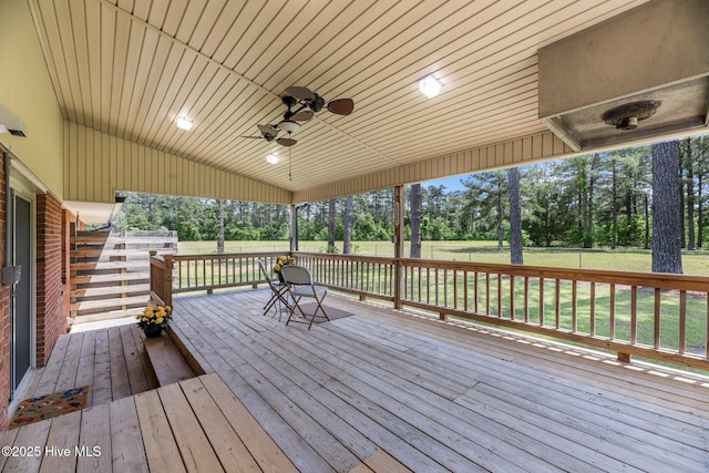 1450 State Camp Rd, Vanceboro, NC 28586 - wooden terrace with view of wooded area, a ceiling fan, and a yard