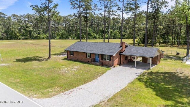 1450 State Camp Rd, Vanceboro, NC 28586 - view of front of house featuring driveway, brick siding, an attached carport, and a chimney