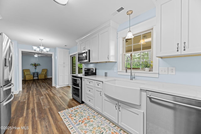 1450 State Camp Rd, Vanceboro, NC 28586 - kitchen featuring appliances with stainless steel finishes, a sink, light countertops, and white cabinetry