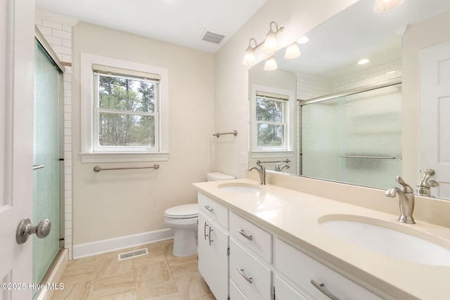 bathroom with visible vents, plenty of natural light, and a sink