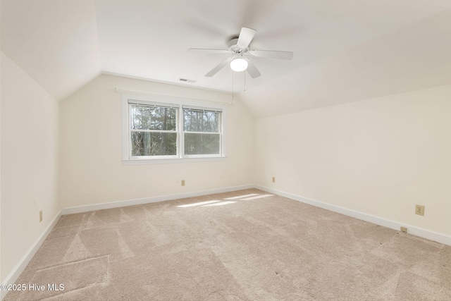 bonus room with a ceiling fan, light colored carpet, visible vents, vaulted ceiling, and baseboards