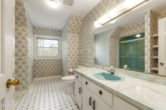 full bath with walk in shower, vanity, toilet, baseboards, and visible vents