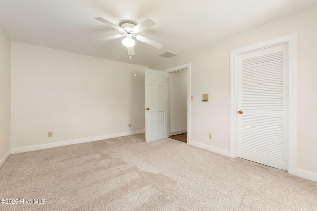 unfurnished bedroom featuring carpet floors, baseboards, and visible vents