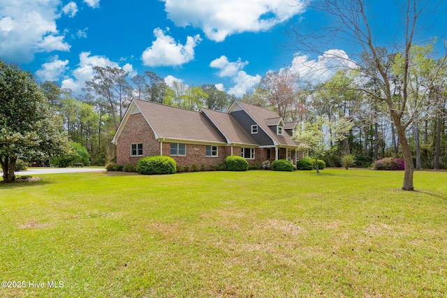 view of side of home featuring a yard and brick siding