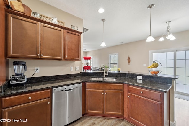 313 March Sea Ln, Jacksonville, NC 28546 - kitchen featuring stainless steel dishwasher, a peninsula, a sink, light wood-style flooring, and pendant lighting