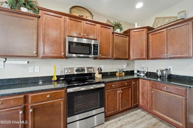 313 March Sea Ln, Jacksonville, NC 28546 - kitchen featuring stainless steel appliances, light wood-style floors, and dark stone counters