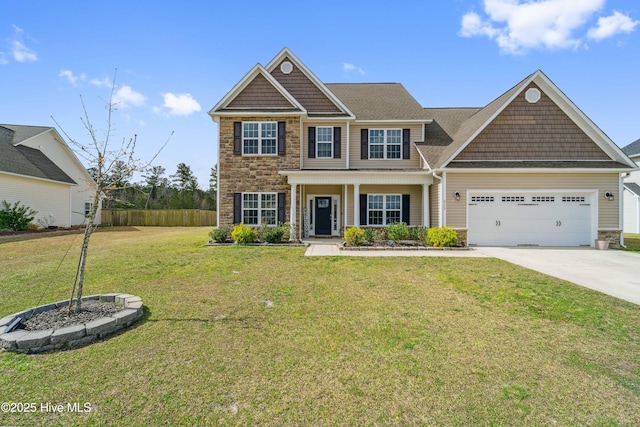 313 March Sea Ln, Jacksonville, NC 28546 - view of front of property with stone siding, concrete driveway, a garage, and covered porch
