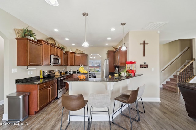 313 March Sea Ln, Jacksonville, NC 28546 - kitchen with appliances with stainless steel finishes, arched walkways, light wood-style floors, and recessed lighting