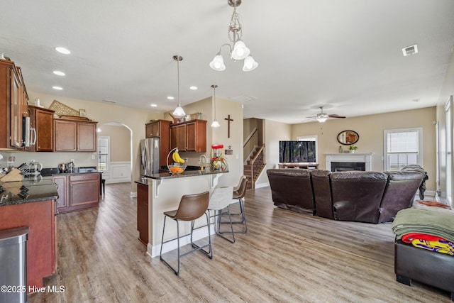 313 March Sea Ln, Jacksonville, NC 28546 - kitchen with open floor plan, stainless steel appliances, a breakfast bar area, arched walkways, and recessed lighting