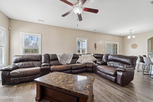 313 March Sea Ln, Jacksonville, NC 28546 - living room with ceiling fan, light wood-style floors, arched walkways, and a chandelier