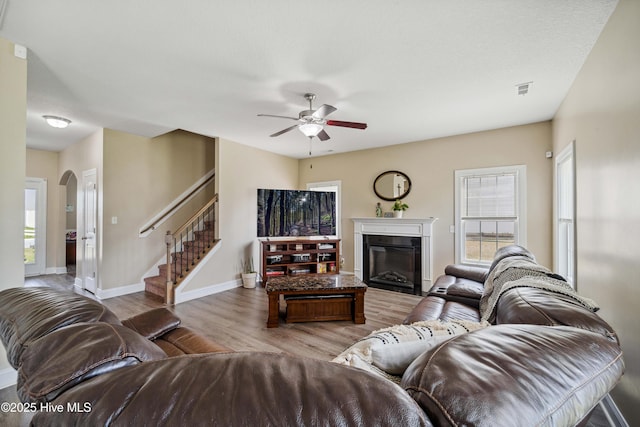 313 March Sea Ln, Jacksonville, NC 28546 - living room featuring ceiling fan, arched walkways, wood finished floors, stairway, and baseboards