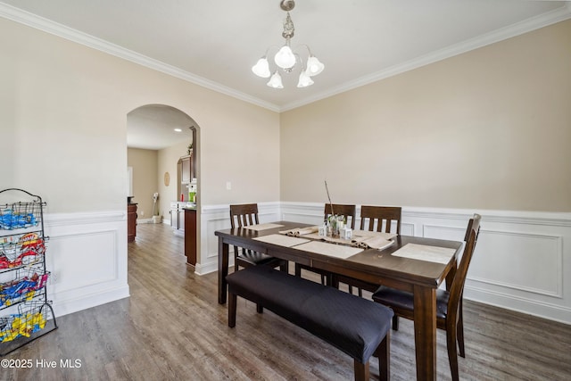 313 March Sea Ln, Jacksonville, NC 28546 - dining room with arched walkways, crown molding, wood finished floors, a chandelier, and wainscoting
