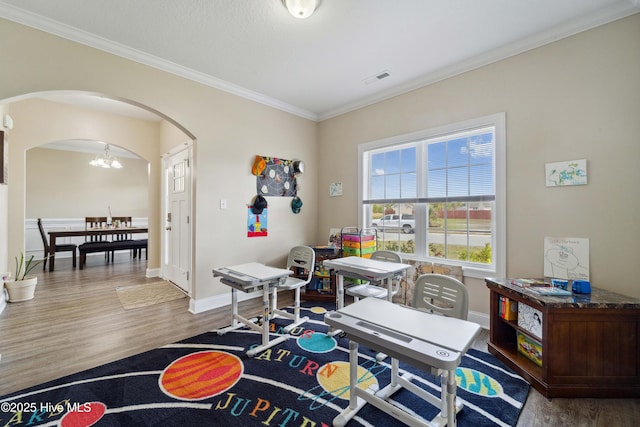 313 March Sea Ln, Jacksonville, NC 28546 - playroom with arched walkways, a chandelier, wood finished floors, ornamental molding, and baseboards