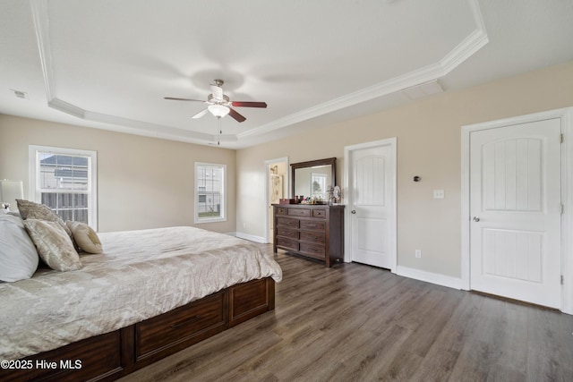 313 March Sea Ln, Jacksonville, NC 28546 - bedroom with a tray ceiling, dark wood-type flooring, crown molding, baseboards, and ceiling fan