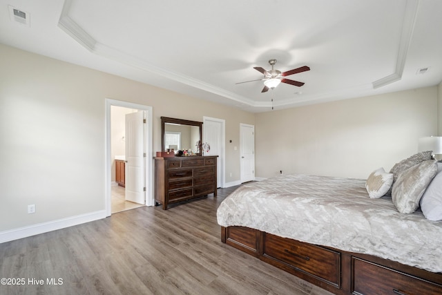 313 March Sea Ln, Jacksonville, NC 28546 - bedroom featuring a tray ceiling, wood finished floors, baseboards, crown molding, and a ceiling fan