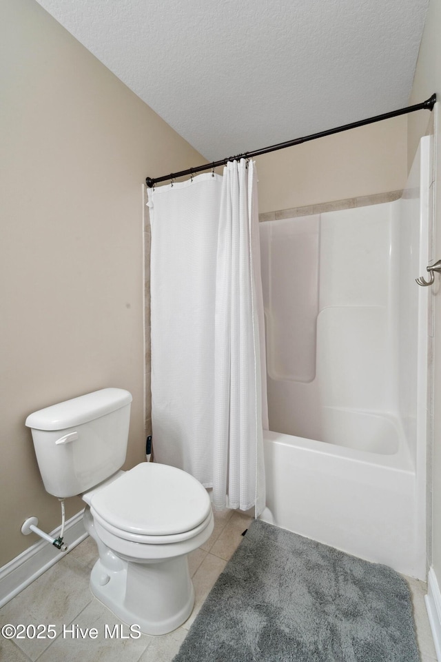 313 March Sea Ln, Jacksonville, NC 28546 - full bathroom with toilet, shower / bath combo with shower curtain, a textured ceiling, tile patterned floors, and baseboards