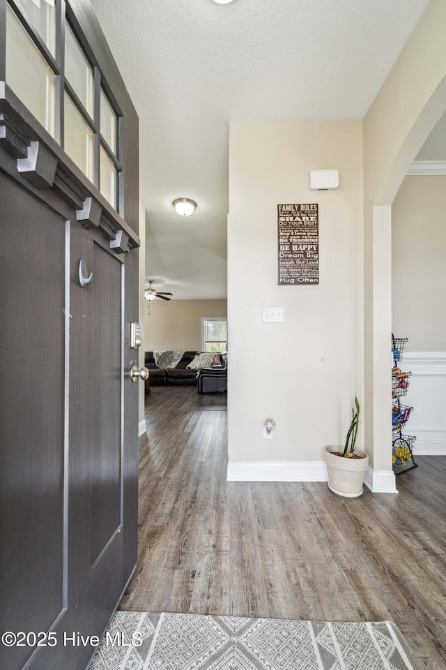 313 March Sea Ln, Jacksonville, NC 28546 - entrance foyer with arched walkways, wood finished floors, baseboards, and ceiling fan