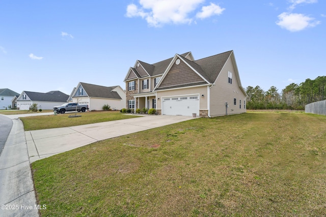 313 March Sea Ln, Jacksonville, NC 28546 - view of property exterior with concrete driveway, stone siding, and a yard