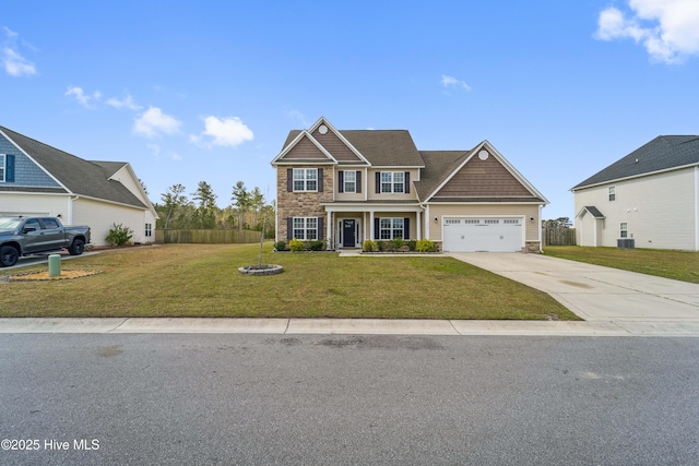 313 March Sea Ln, Jacksonville, NC 28546 - craftsman inspired home featuring stone siding, driveway, a garage, and central air condition unit