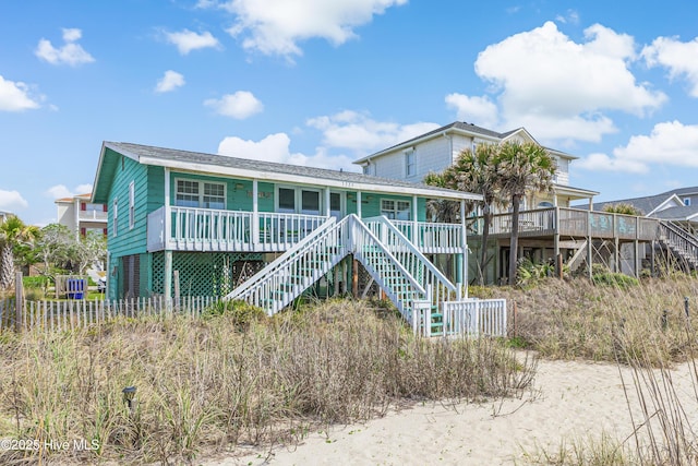 3325 W Beach Dr, Oak Island, NC 28465 - back of house with stairway and covered porch