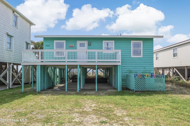 3325 W Beach Dr, Oak Island, NC 28465 - rear view of property with a lawn and a deck