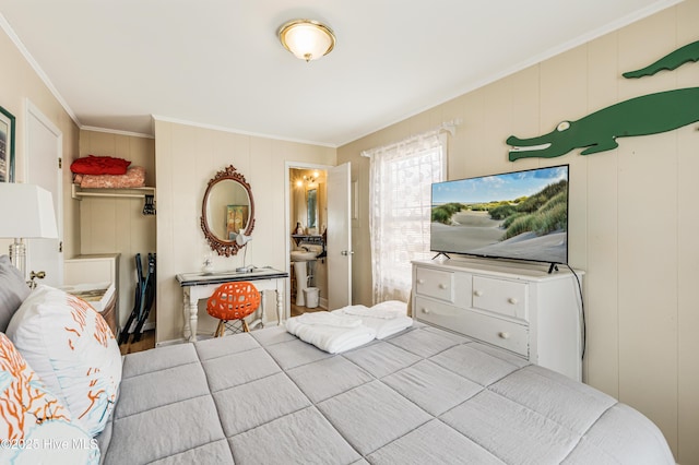 3325 W Beach Dr, Oak Island, NC 28465 - bedroom featuring crown molding, a decorative wall, and wood finished floors