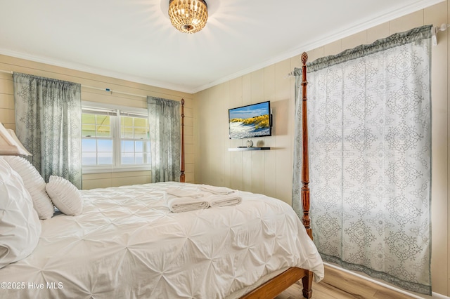3325 W Beach Dr, Oak Island, NC 28465 - bedroom with crown molding, wood finished floors, and wood walls