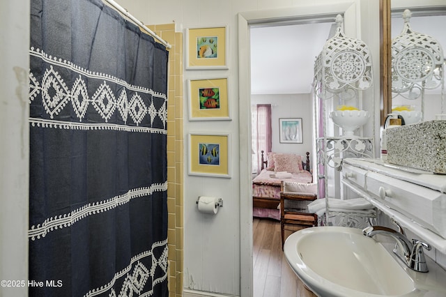 3325 W Beach Dr, Oak Island, NC 28465 - bathroom featuring wood finished floors, ensuite bath, and a shower with curtain