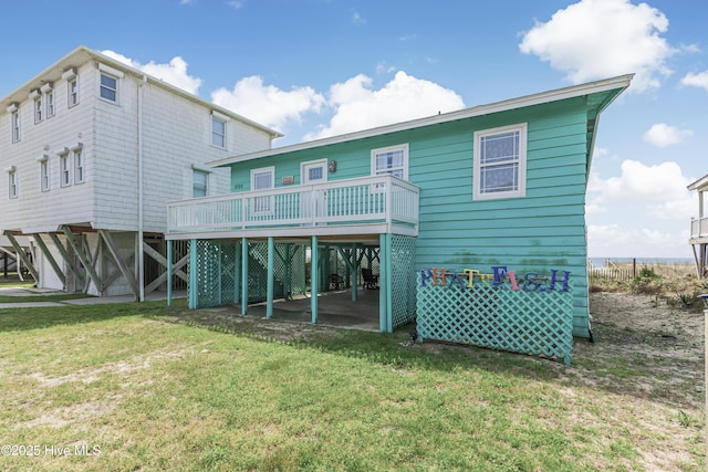 3325 W Beach Dr, Oak Island, NC 28465 - back of house featuring a yard and a wooden deck