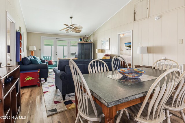3325 W Beach Dr, Oak Island, NC 28465 - dining area with lofted ceiling, ceiling fan, wood finished floors, crown molding, and french doors