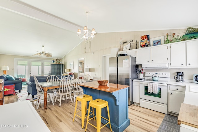 3325 W Beach Dr, Oak Island, NC 28465 - kitchen with white electric range, freestanding refrigerator, light wood-style floors, and under cabinet range hood