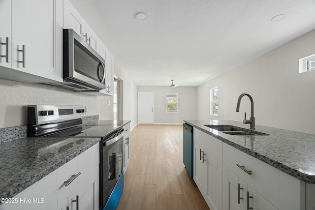 810 Morgan St, Elizabeth City, NC 27909 - kitchen featuring a sink, white cabinetry, appliances with stainless steel finishes, and dark stone counters