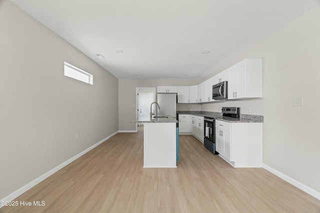 810 Morgan St, Elizabeth City, NC 27909 - kitchen with light stone countertops, appliances with stainless steel finishes, baseboards, and light wood-type flooring