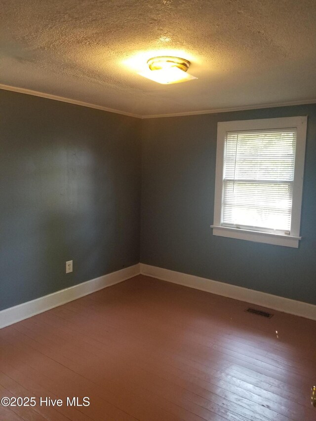 403 Jamesville Rd, Williamston, NC 27892 - empty room with hardwood / wood-style floors, ornamental molding, and visible vents