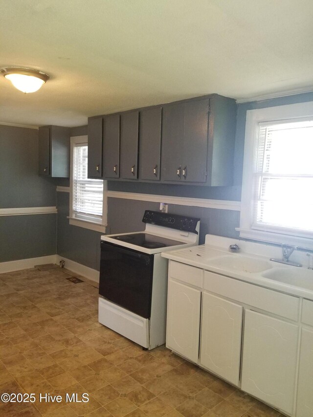 403 Jamesville Rd, Williamston, NC 27892 - kitchen with gray cabinetry, range with electric stovetop, baseboards, and white cabinets