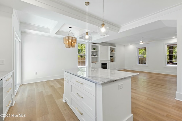 kitchen featuring white cabinets, a fireplace, light wood-style floors, and crown molding
