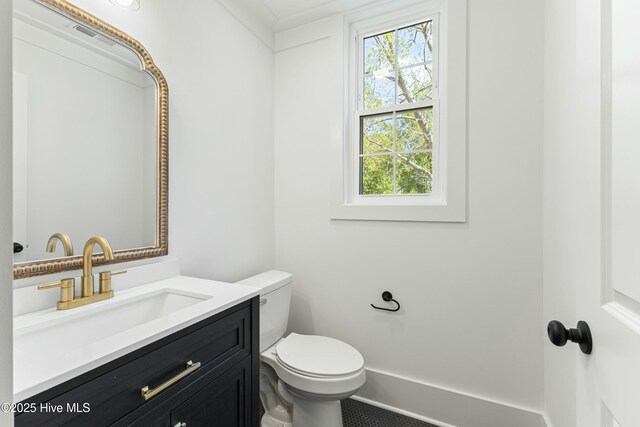 bathroom featuring vanity and toilet