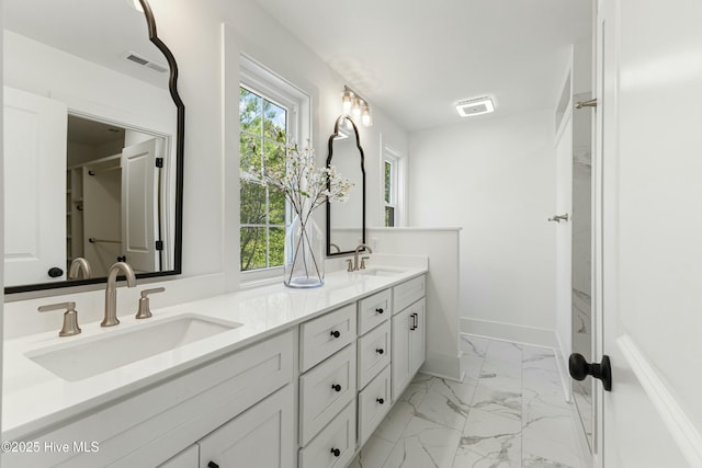 bathroom with a sink, visible vents, double vanity, and marble finish floor